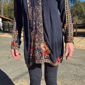 Johnny was  dark navy color tunic or dress